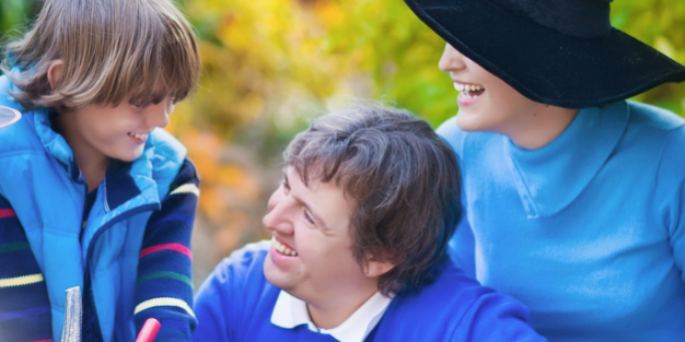 Family enjoying Halloween pumpkin carving outdoors