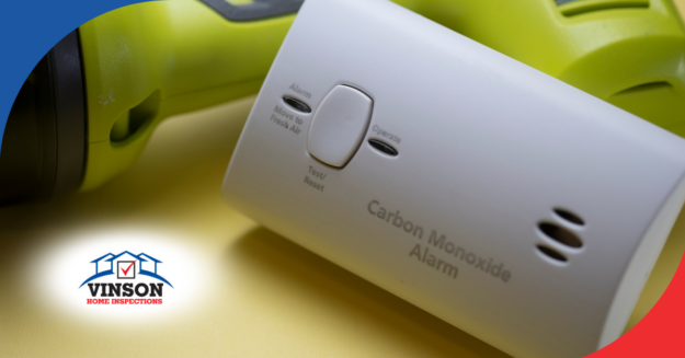 Carbon monoxide alarm placed next to a flashlight