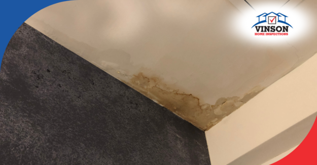 Water-stained ceiling corner showing signs of moisture damage.