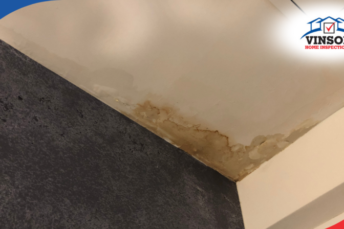Water-stained ceiling corner showing signs of moisture damage.