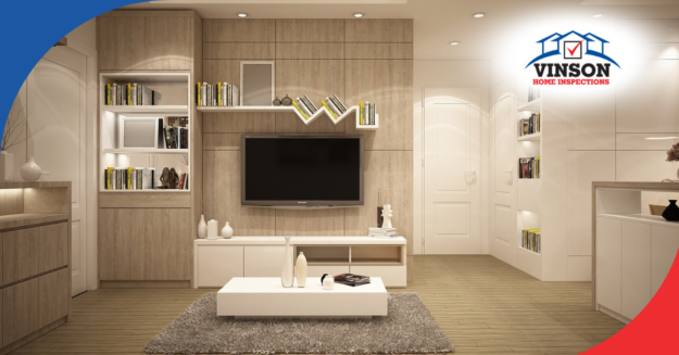 Modern living room with built-in shelving, flat-screen TV, and minimalistic decor.