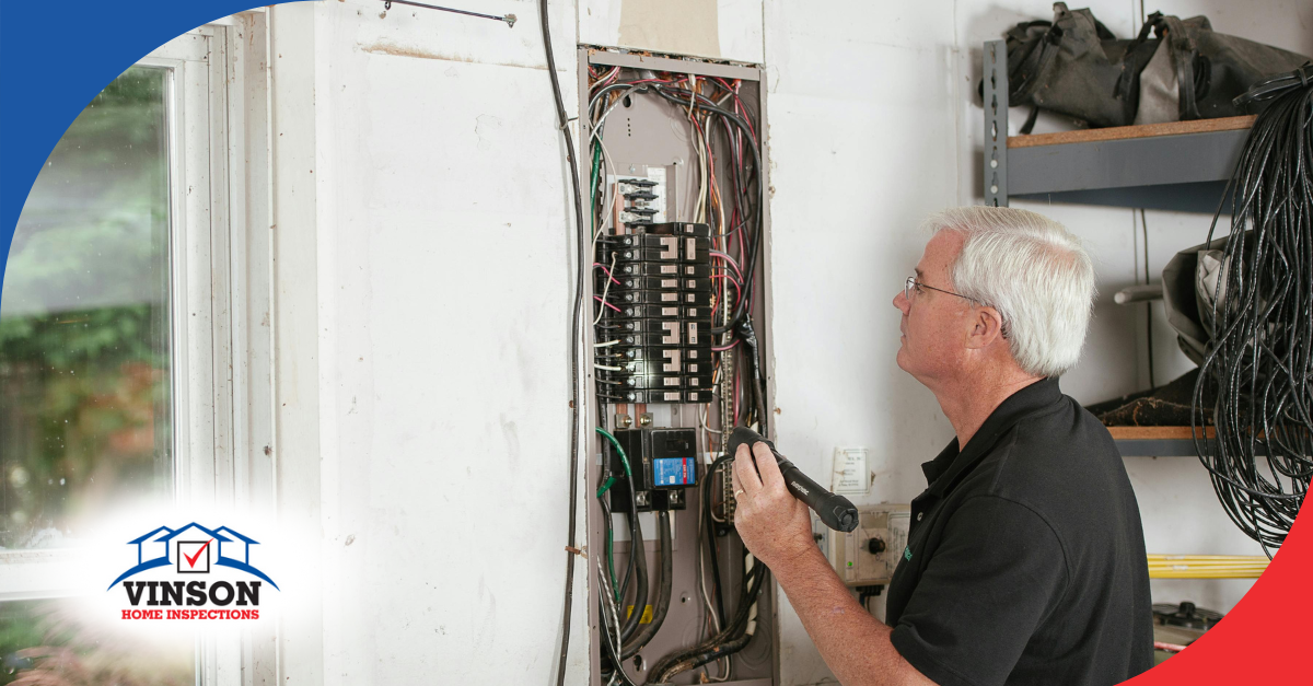 Home inspector performing an electrical panel inspection at a property