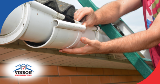 Hands repairing a white plastic roof gutter.