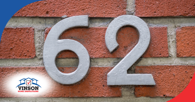 Gray house number 62 on a red brick wall