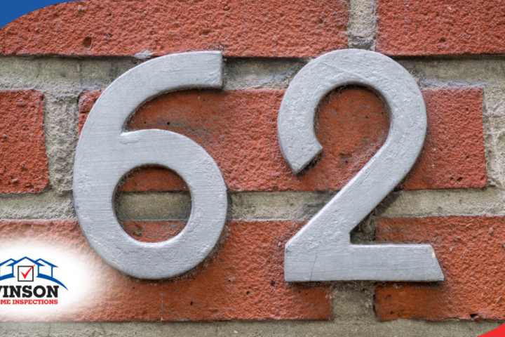 Gray house number 62 on a red brick wall