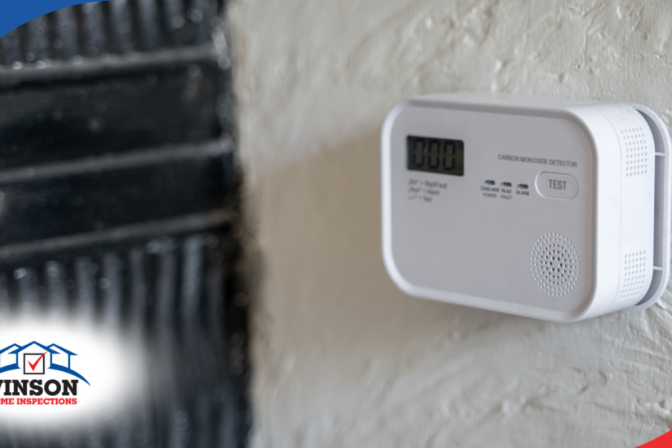 Vinson Home Inspections Carbon monoxide detector with digital display mounted on a wall.