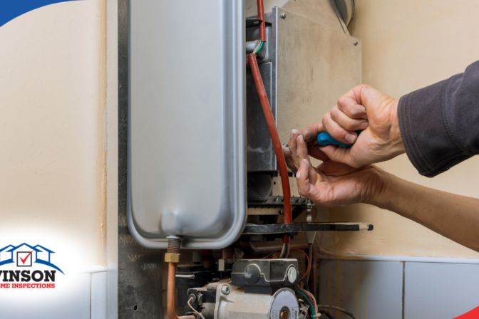 Technician repairing a wall-mounted water heater.
